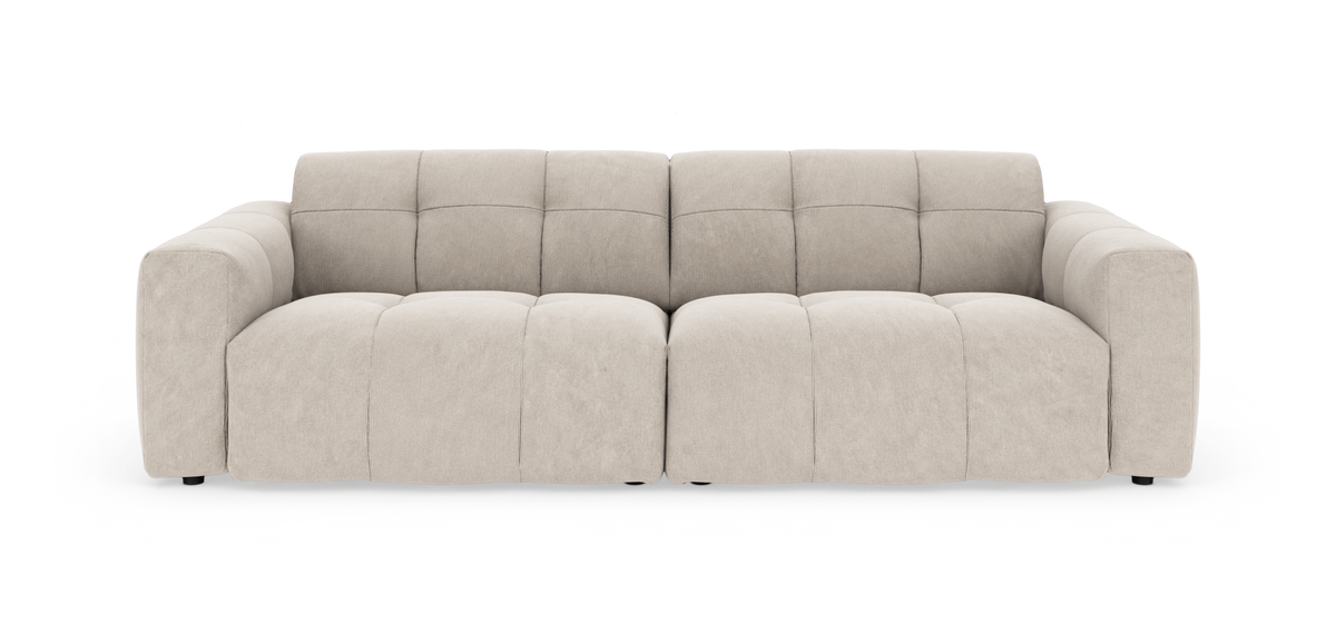 Beige modulsofa med blød, voluminøs design set forfra på hvid baggrund.