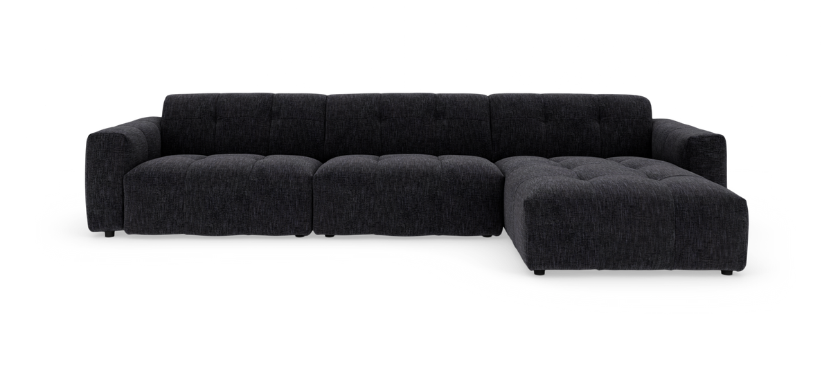 Modulsofa i mørkegråt stof, L-form med højre chaiselong på hvid baggrund.