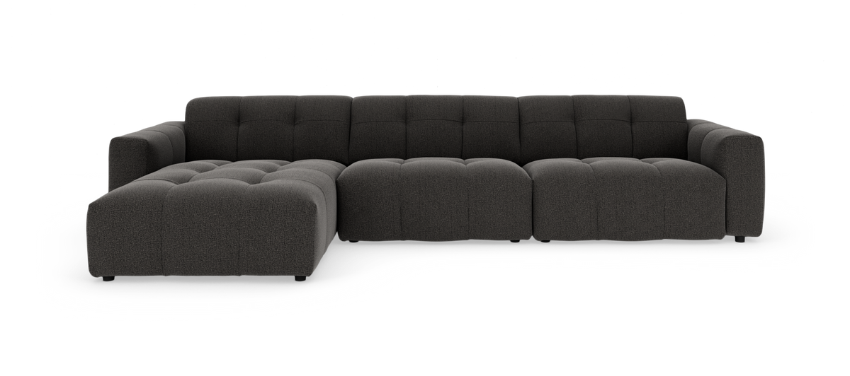 Mørkegrå modulsofa med chaiselong og tuftet sæde, frilagt på hvid baggrund.