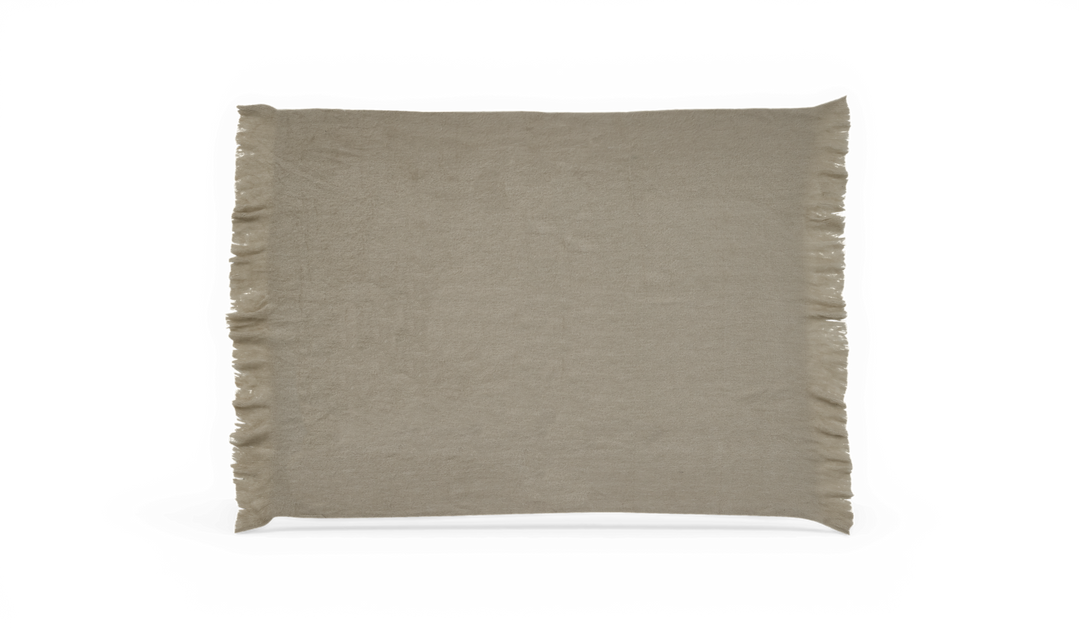 Beige plaid med frynser langs kanterne, frilagt.