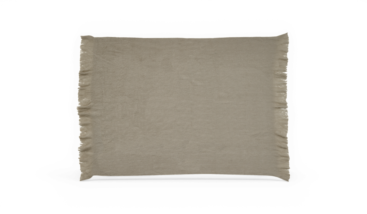 Beige plaid med frynser langs kanterne, frilagt.
