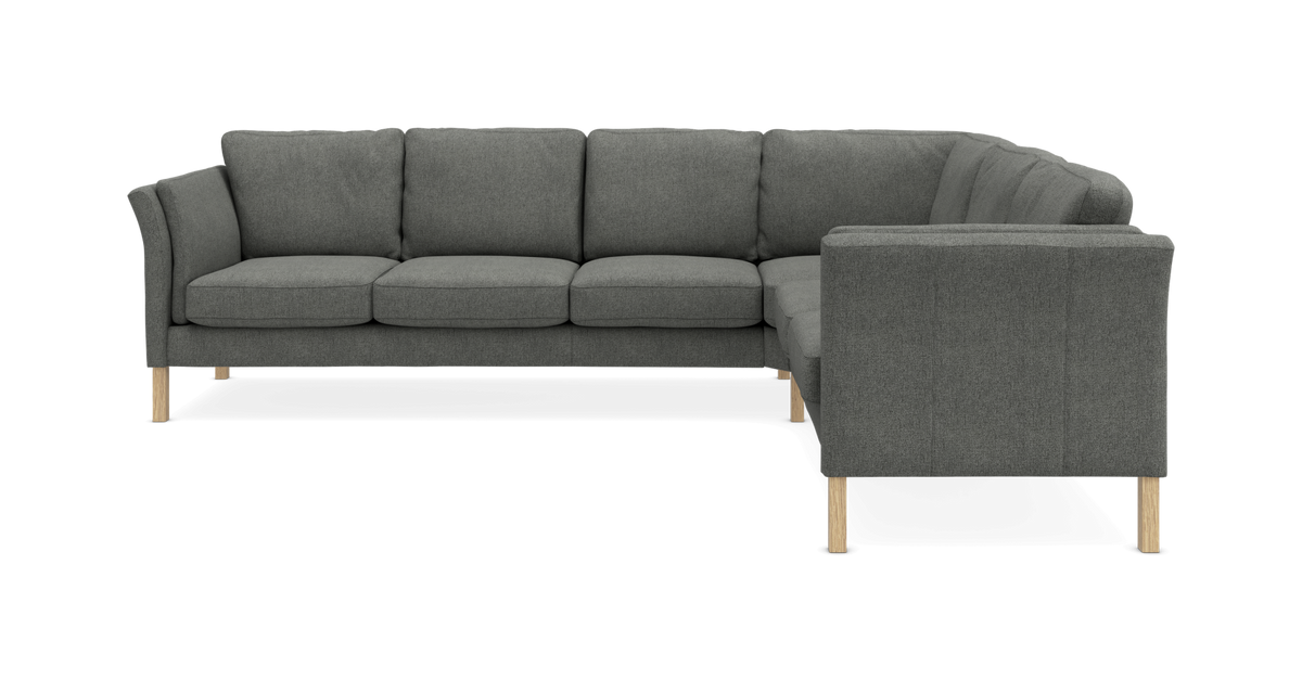 Mørkegrå hjørnesofa med træben på hvid baggrund.
