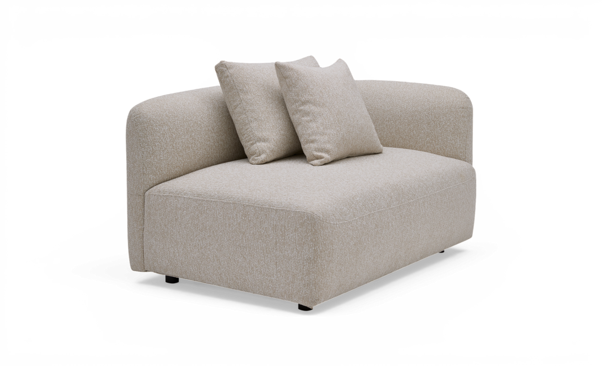 Beige modulsofa i stof med rund ryglæn og to løse puder, frilagt produktbillede.