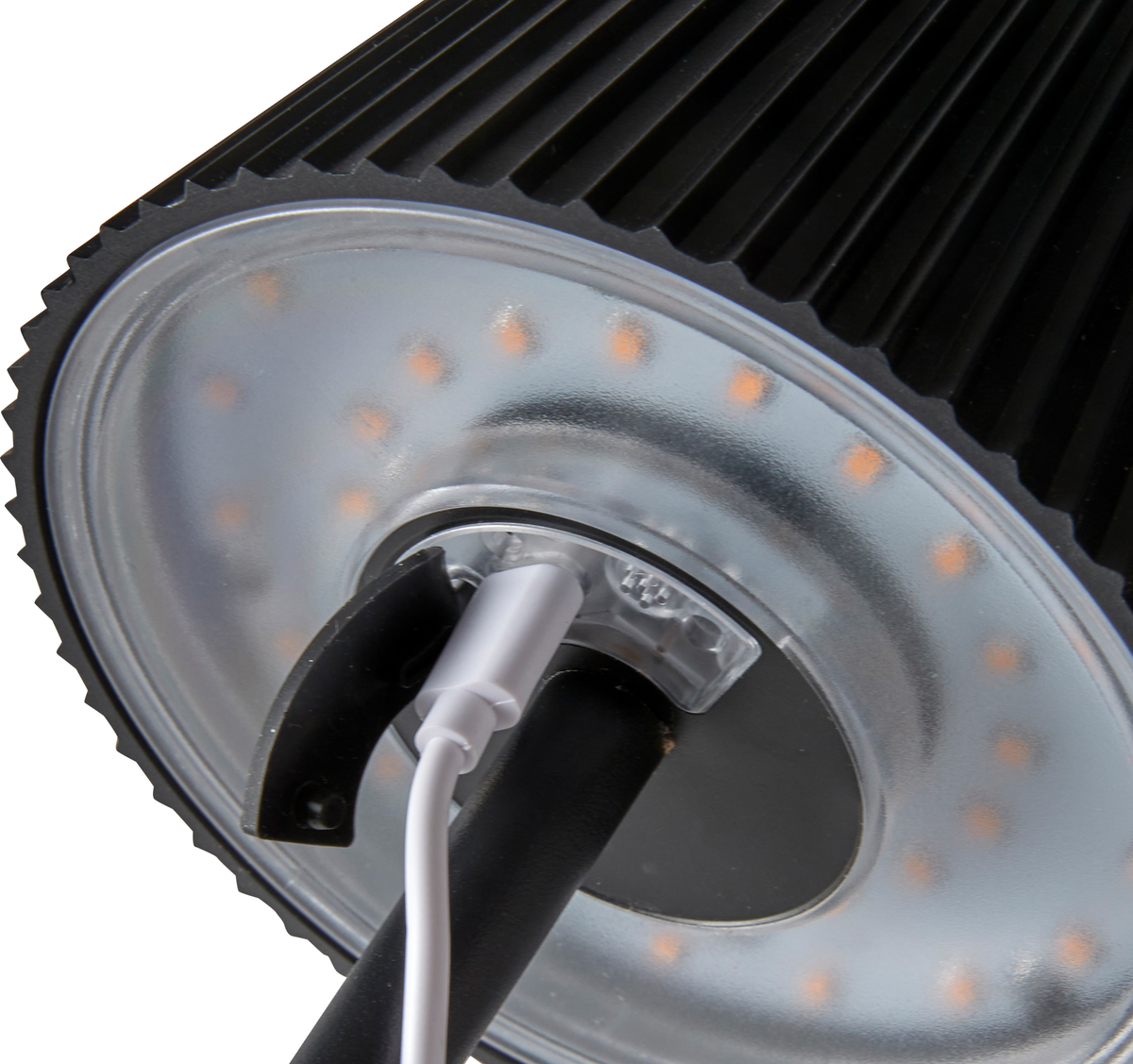 Nærbillede af undersiden af en sort LED‑lampe med cirkulær række dioder og tilsluttet strømkabel.