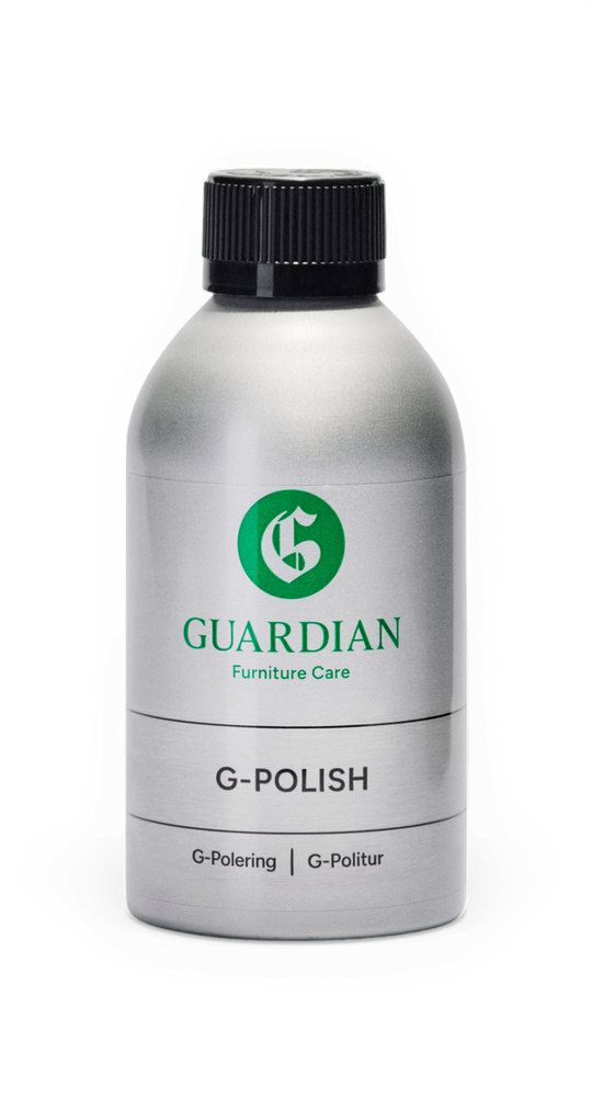 Sølvfarvet flaske med sort låg: Guardian Furniture Care G‑POLISH, markeret "G‑Polering | G‑Politur".