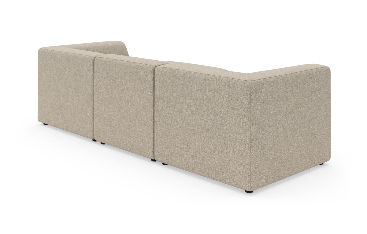 Beige modulsofa set bagfra i studie med rene linjer.