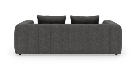 Mørkegrå kanalquiltet 3-personers sofa med to ryghynder set lige forfra på hvid studiebaggrund.