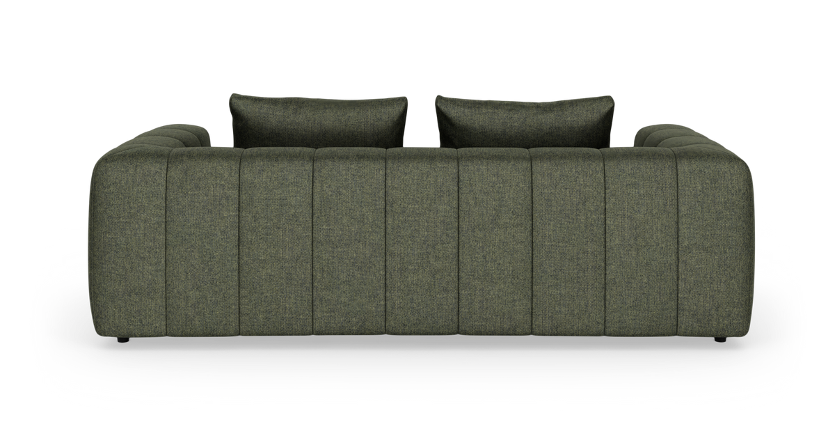 Grøn sofa med to ryghynder, set lige forfra mod hvid studiobaggrund.