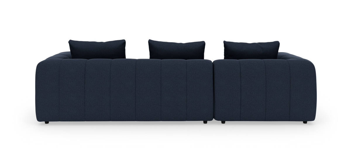 Mørkeblå modulsofa med tre ryghynder set forfra på hvid baggrund.
