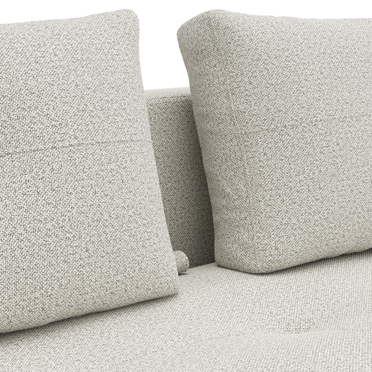 Nærbillede af lysebeige sofa med to rygpuder i tekstureret stof.