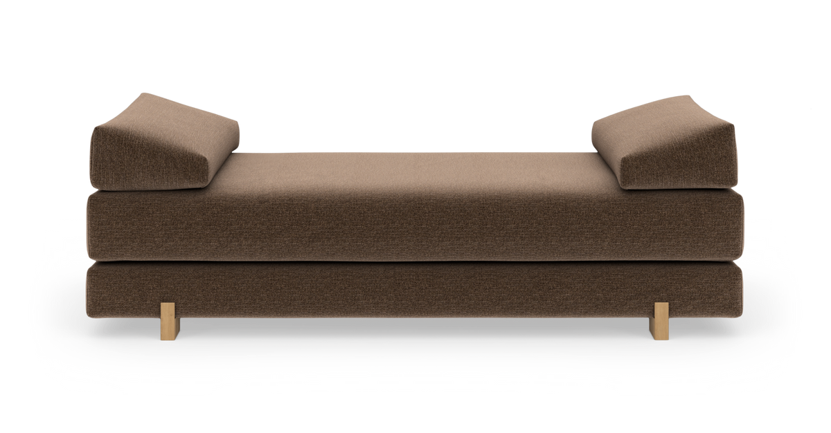 Brun daybed med to vinklede armlæn og små træben, fritlagt på hvid baggrund.