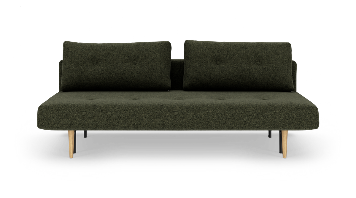 Mørkegrøn sofa med to ryghynder og koniske træben, frilagt på hvid baggrund.