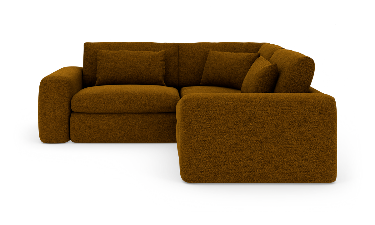 L‑formet brun bouclé‑modulsofa med afrundede armlæn og løse puder, frilagt på hvid baggrund.