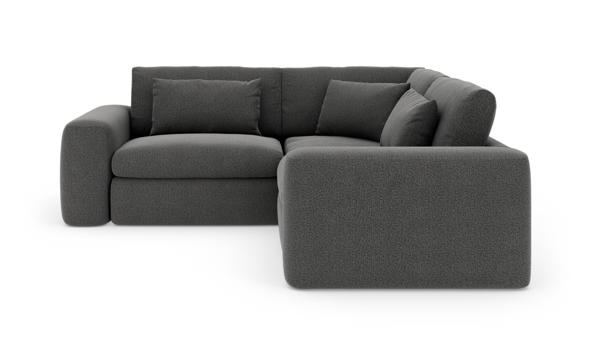 Mørkegrå hjørnesofa i stof med afrundede armlæn og løse ryghynder.