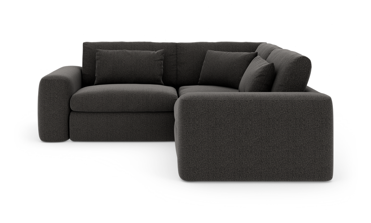 Mørkegrå modulær hjørnesofa med afrundede armlæn og tre løse ryghynder, frilagt mod hvid baggrund.