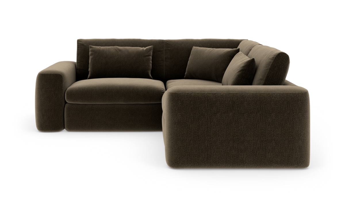 Mørkebrun modul-hjørnesofa med afrundede former og løse puder, frilagt.