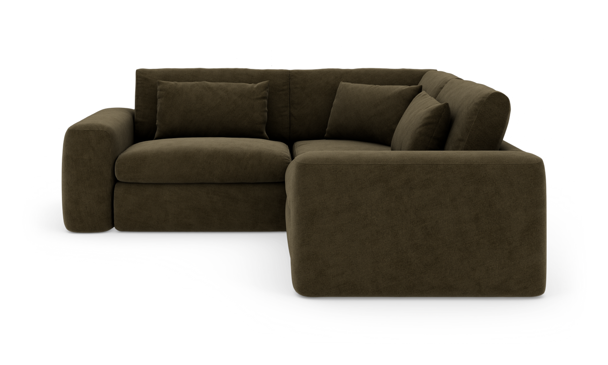 Mørkebrun L‑formet hjørnesofa i fløjl/cord med højre chaiselong, brede armlæn og løse ryghynder.