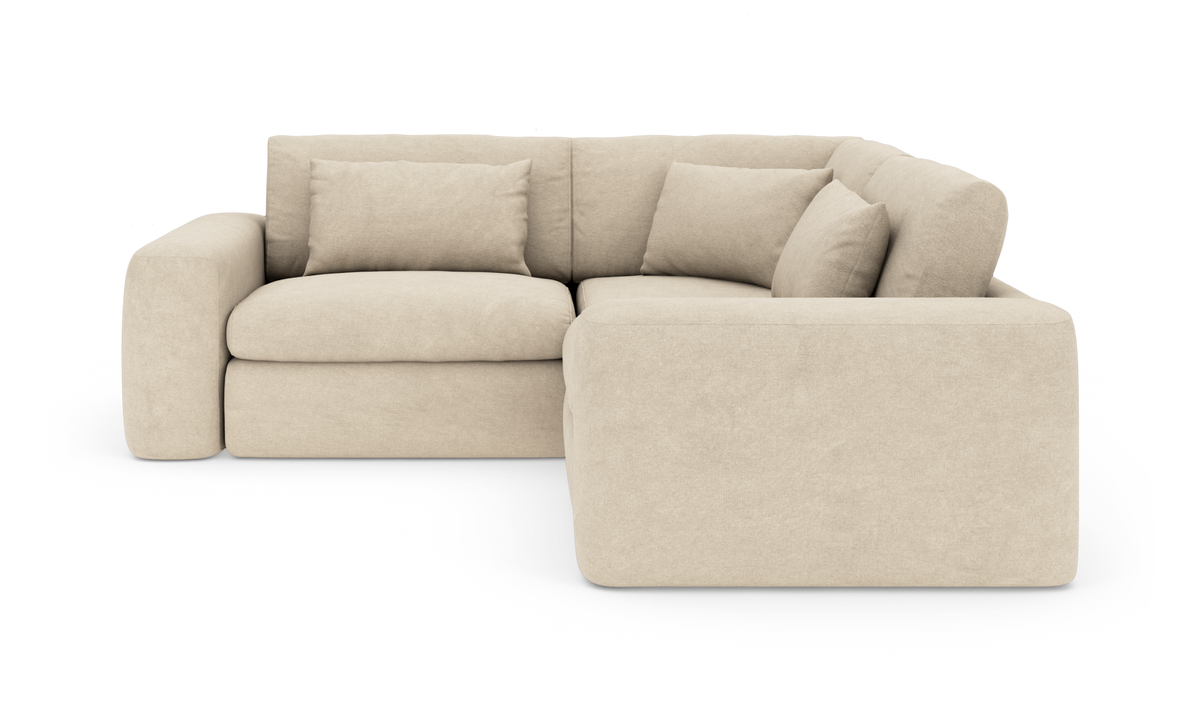 Beige L-formet modulsofa med højre chaiselong og bløde puder.