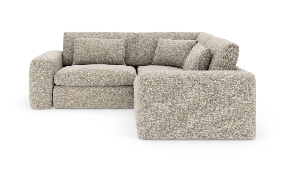 Beige L‑sofa med afrundede former og løse ryghynder på hvid baggrund.
