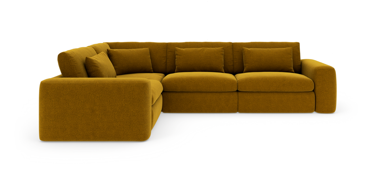 Sennepsgul modul-hjørnesofa med store puder, frilagt på hvid baggrund.