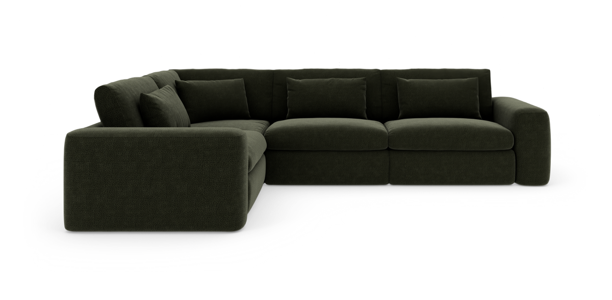 Mørkegrøn modulhjørnesofa med ryg- og pyntepuder.