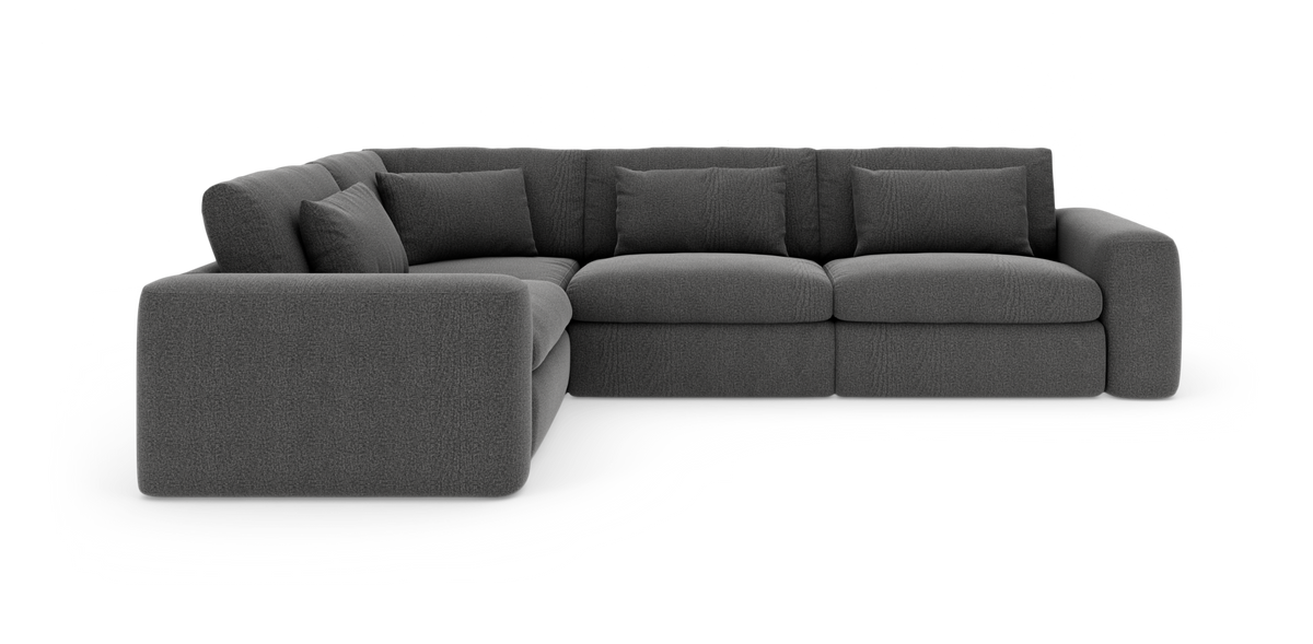 Mørkegrå modulær hjørnesofa med brede armlæn og løse ryghynder.