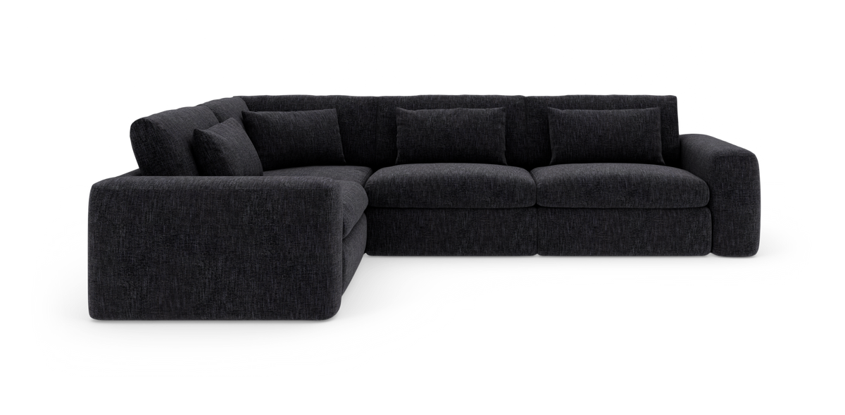 Mørkegrå modulhjørnesofa i L/U‑form med dybe sæder og løse ryghynder, frilagt på hvid baggrund.