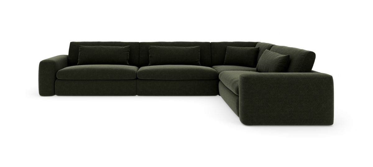 Mørkegrøn modul hjørnesofa med brede armlæn og dybe sædehynder.
