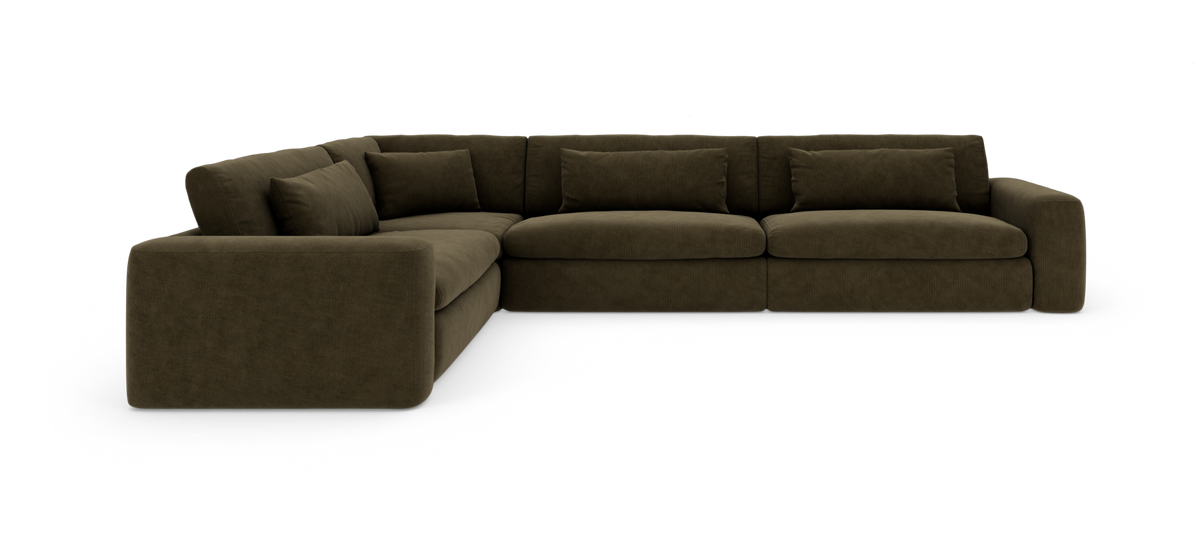 Modulær L‑formet hjørnesofa i mørke olivengrøn bredriflet fløjl med dybe sæder og løse puder.