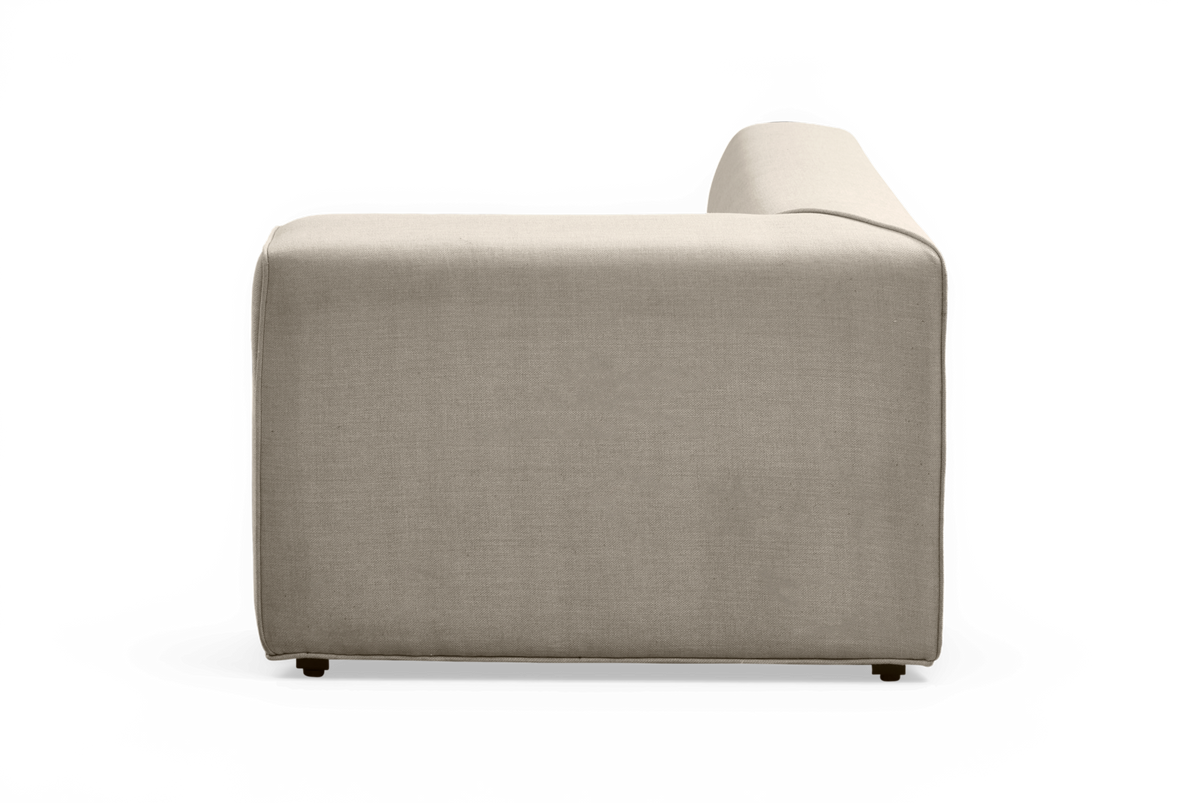 Beige modulsofa i stof set fra siden med armlæn på højre side; fritlagt produktfoto.