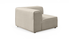 Beige modulsofa i stof – hjørnemodul med lav ryg, frilagt på hvid baggrund.