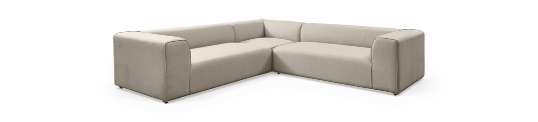Beige L‑formet modulsofa i stof med brede armlæn, fritlagt på sort baggrund.