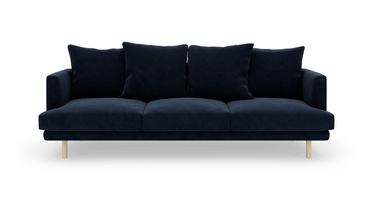 Mørkeblå tresæders sofa med fire rygpuder og lyse træben, set forfra.