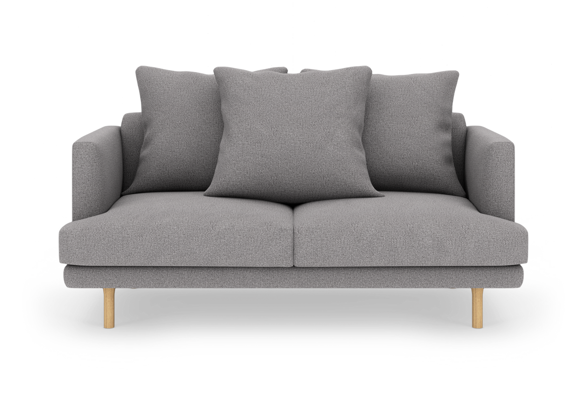 Grå 2-personers sofa med tre puder og træben, frilagt på hvid baggrund.