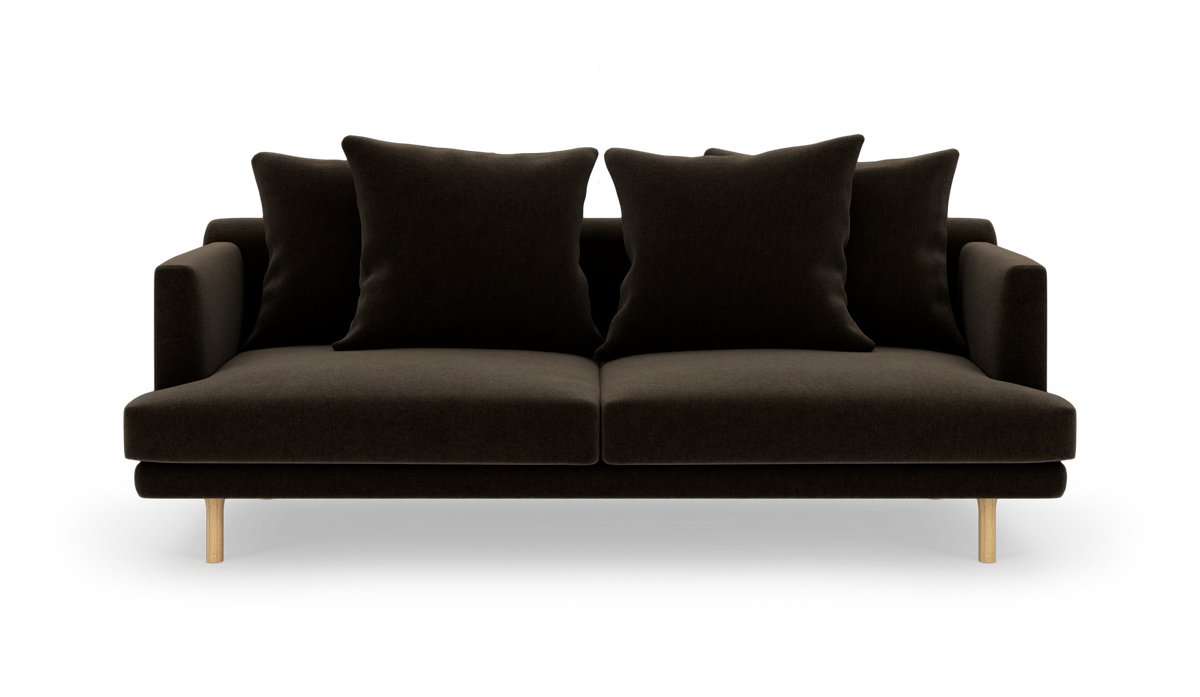 Mørkebrun 2-personers sofa med fire store puder og lyse træben, frontvisning mod hvid frilagt baggrund.