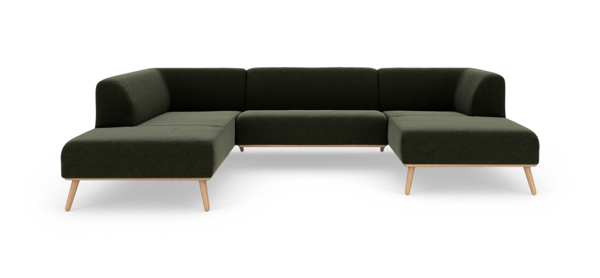 Modulær hjørnesofa i mørkegrønt stof med lyse træben, frilagt på hvid baggrund.