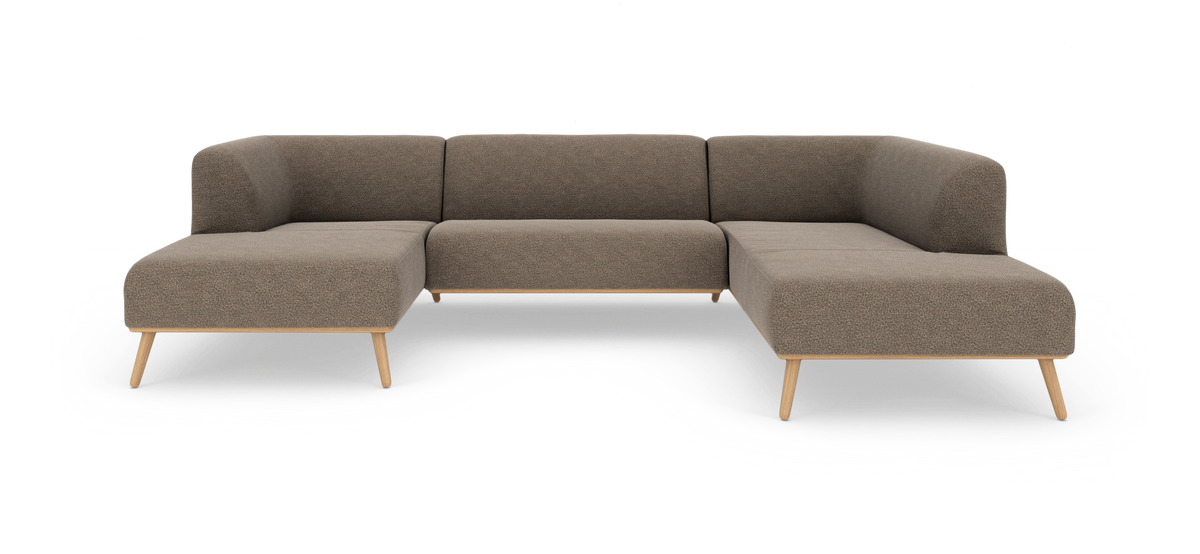 U‑formet modulsofa i beige stof med lyse træben, frilagt på hvid baggrund.