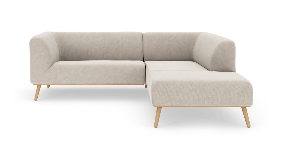 L‑formet beige modulsofa med afrundede armlæn og træben på hvid baggrund.