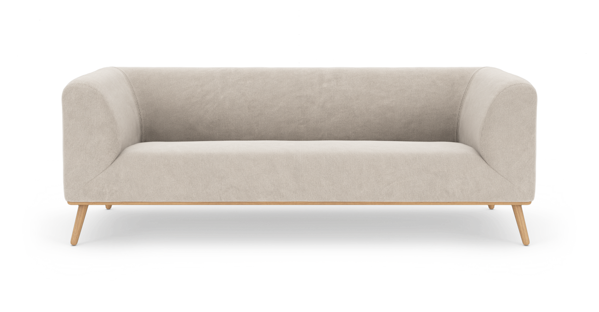 Lys beige 3-personers sofa med afrundede armlæn og slanke træben, frilagt på hvid baggrund.