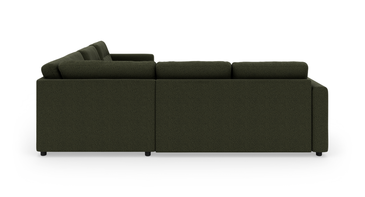 Mørkegrøn L‑formet modulsofa i stof, set bagfra på hvid baggrund.