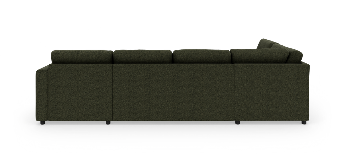 Mørkegrøn modulsofa i stof set bagfra på hvid baggrund.