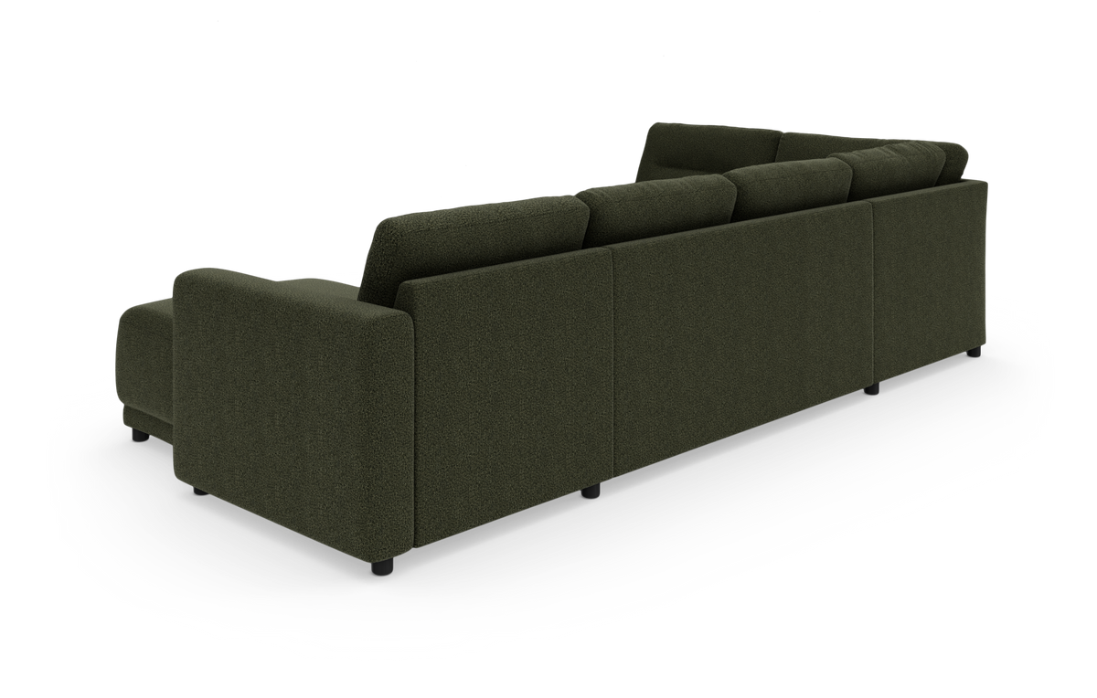 Mørkegrøn modulhjørnesofa med chaiselong, set bagfra i studie.