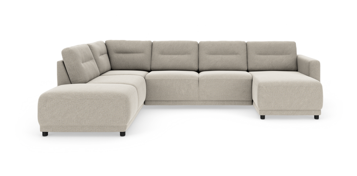 Beige modulsofa i U‑form med chaiselong til højre, bløde afrundede former og lave sorte ben.