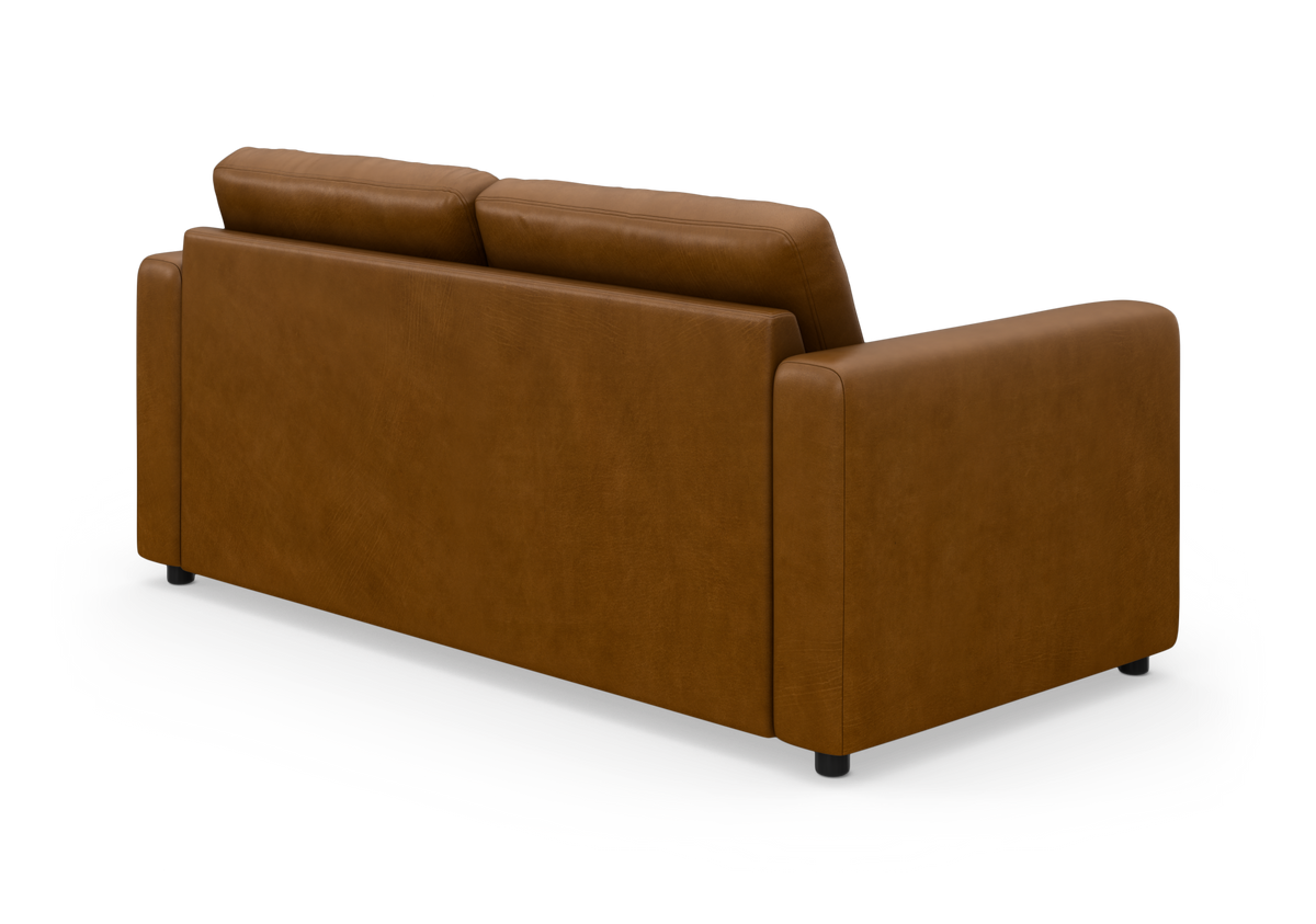 Brun lædersofa set bagfra i studiemiljø.