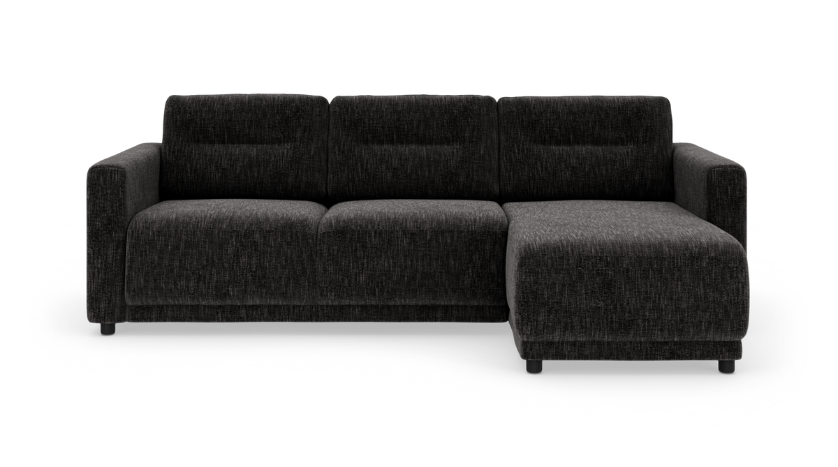Mørkegrå stofsofa med chaiselong til højre, frilagt på hvid baggrund.