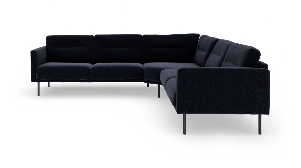 Mørkeblå modulær L‑formet hjørnesofa med slanke metalben, frilagt på hvid baggrund.