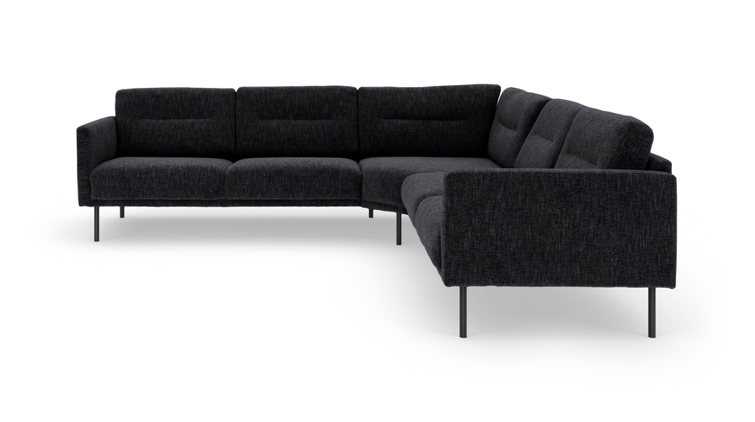 Mørkegrå L‑formet modulsofa med slanke metalben, fritlagt på hvid baggrund.