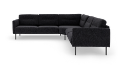 Mørkegrå L‑formet modulsofa med slanke metalben, fritlagt på hvid baggrund.