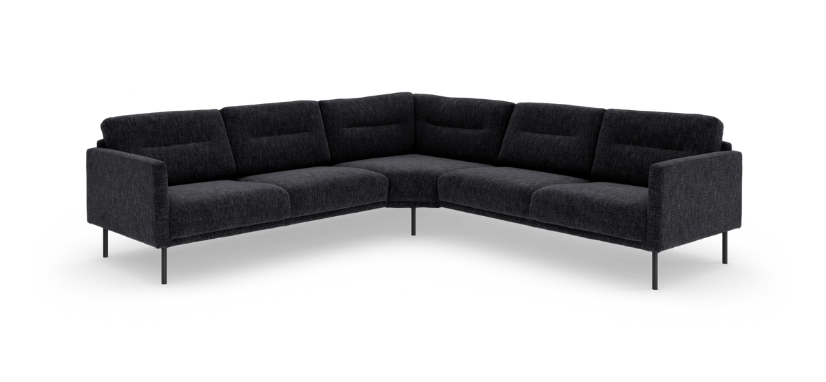 Mørkegrå L-formet modulsofa med slanke metalben, frilagt på hvid baggrund.
