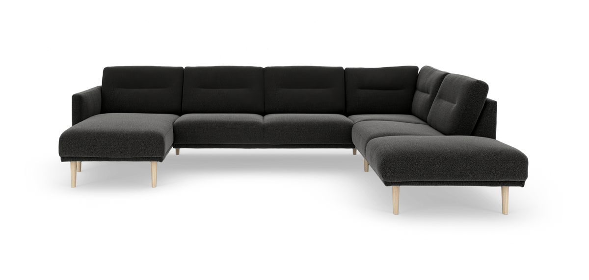 Mørkegrå modulsofa i U‑form med lyse træben, fritlagt på hvid baggrund.